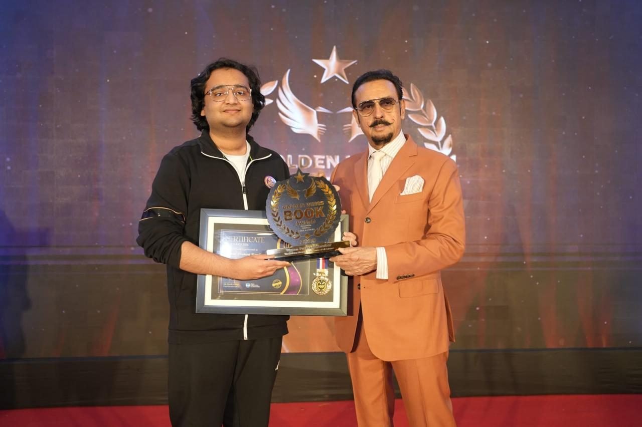 Vivaan Karulkar receiving the Golden Wings Book Award from actor Gulshan Grover