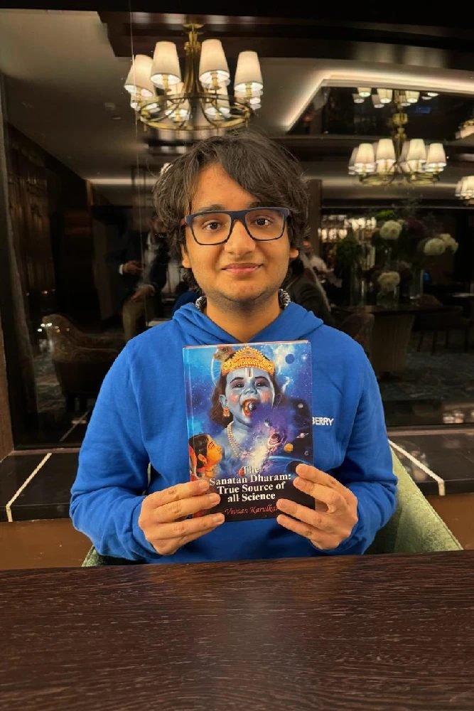 Vivaan Karulkar holding a copy of his first book, The Sanatan Dharam: True Source of all Science